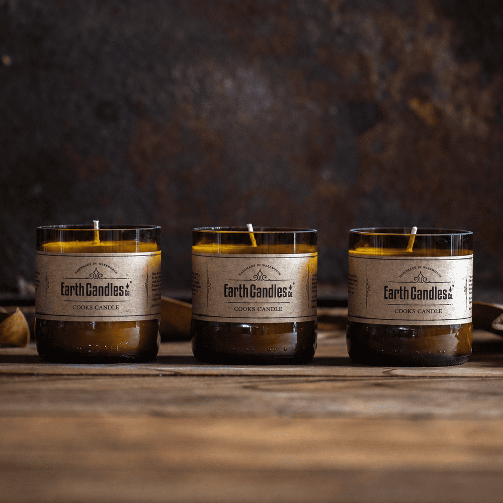 Three Cooks Candle soy tealights by Earth Candles Co., unlit, in cut amber beer bottle bases