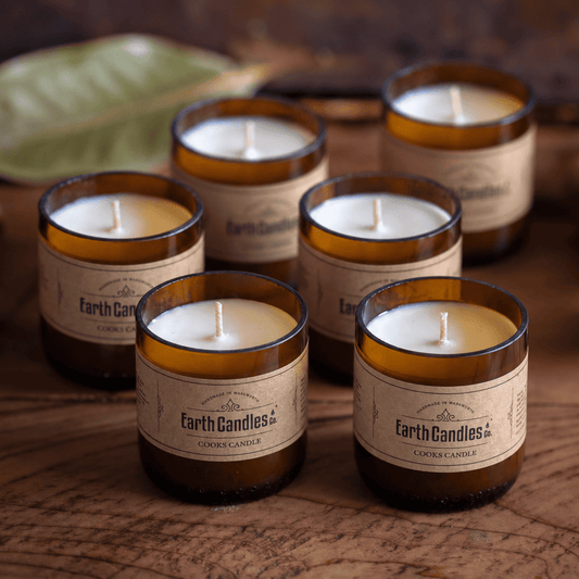Six Cooks Candle soy tealights, unlit, grouped in their cut amber beer bottle bases