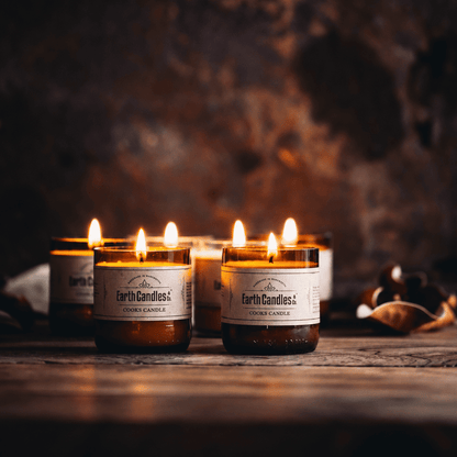 Six Cooks Candle soy tealights burning in cut amber beer bottle bases