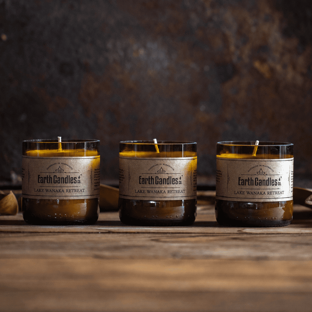 Three Lake Wanaka Retreat soy tealights by Earth Candles Co., unlit, in cut amber beer bottle bases