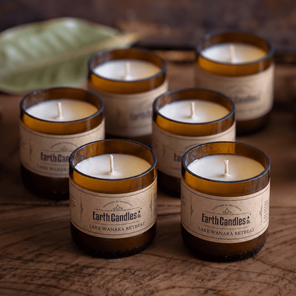 Six Lake Wanaka Retreat soy tealights, unlit, grouped in their cut amber beer bottle bases