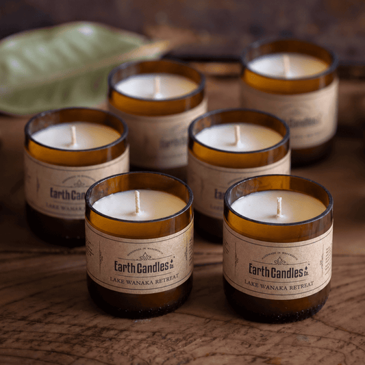 Six Lake Wanaka Retreat soy tealights, unlit, grouped in their cut amber beer bottle bases