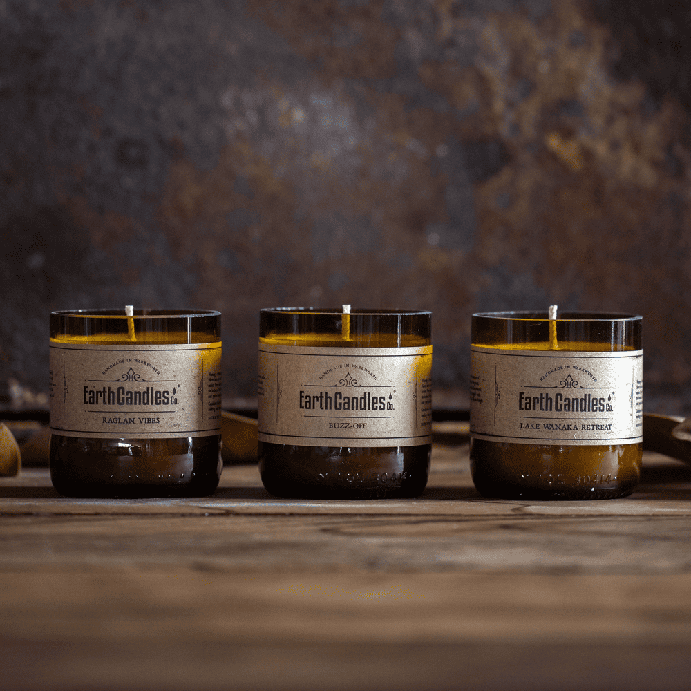 Three soy tealights in cut amber beer bottle bases: Raglan Vibes, Buzz-Off and Lake Wanaka Retreat