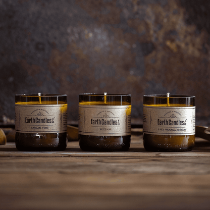 Three soy tealights in cut amber beer bottle bases: Raglan Vibes, Buzz-Off and Lake Wanaka Retreat